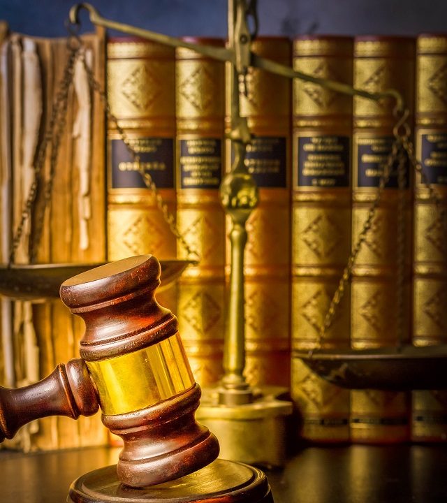 Law and justice concept - law gavel with row of books, retro toned